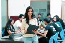 Student with classmates in a lab